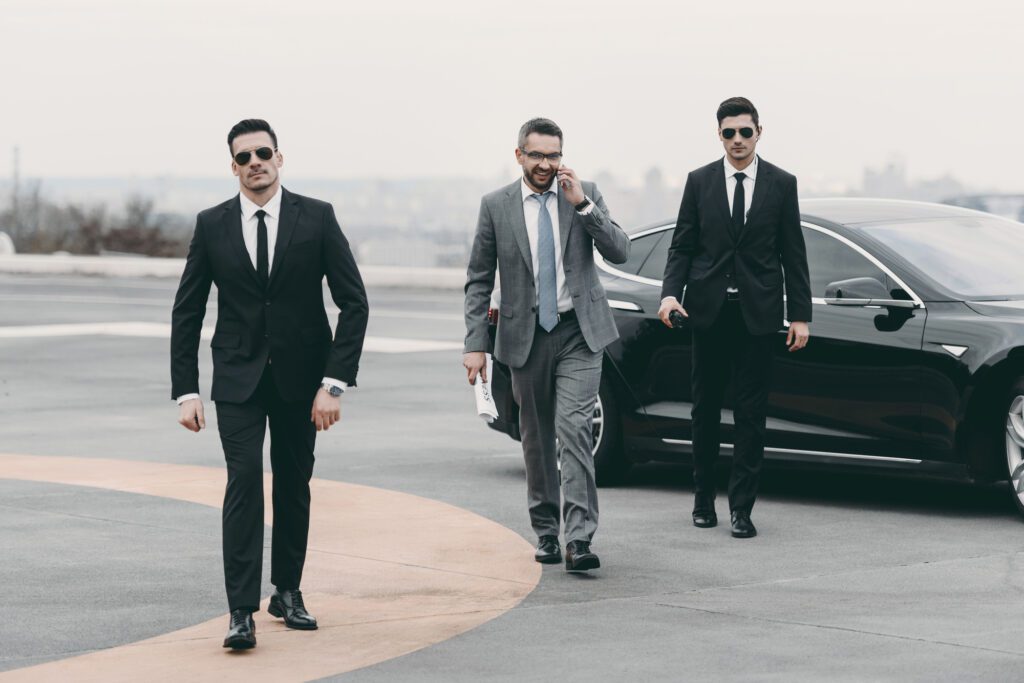 Businessman Accompanied By Security Guards